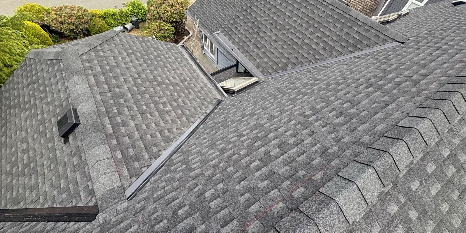 Aerial view of a completed architectural shingle roof replacement in Vancouver, BC