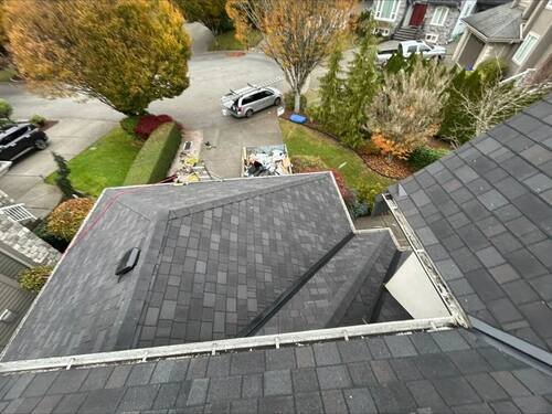 Full Roof Replacement — Aerial of the finished multi-plane roof, valleys and hips all cut clean.