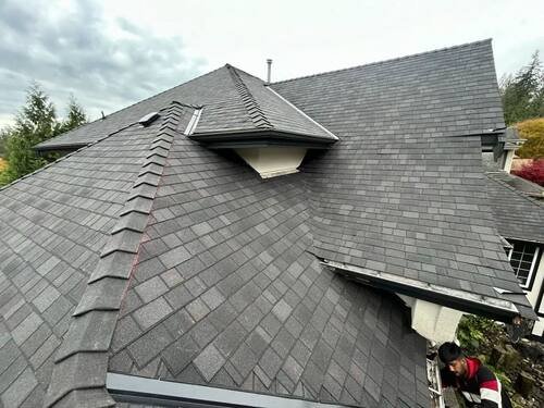 Storm Damage Restoration — Old, damaged shingles stripped off and staged for haul-away.